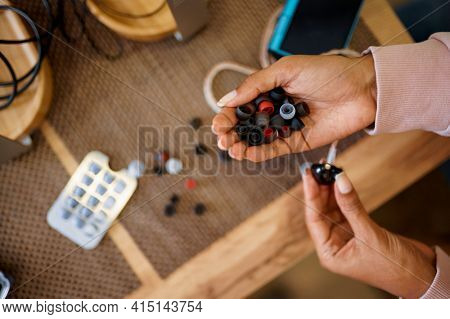 Woman choosing ear pads in audio store