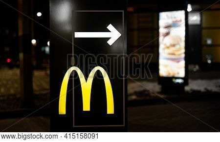 Kyiv, Ukraine - 05 Fabruary 2021: Yellow signboard of McDonalds restaurant with white arrow showing way to McDrive