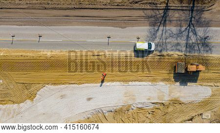 Above Top View, Overhead On Huge Road Roller With Spikes Is Compacting Soil, Sand At Building Site F