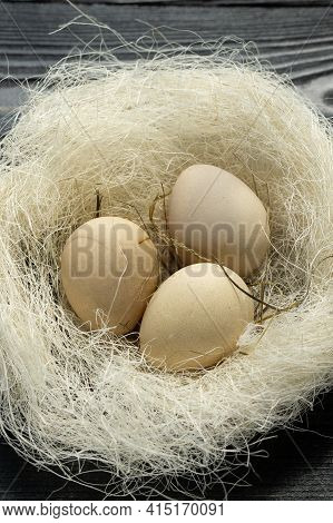 Blackbird Eggs Are Light Brown In An Artificial Decorative Nest. Festive Decor Of Fresh Eggs For Eas