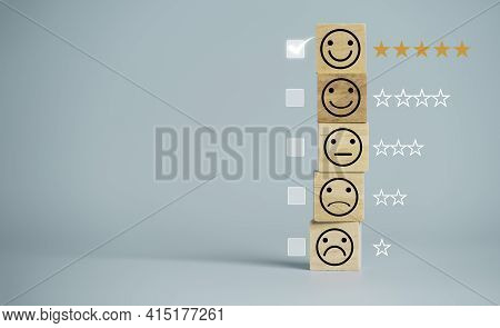 Customer Satisfaction Survey Concept, Human Face Icons Print Screen On Wooden Cube Block With Stars 