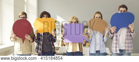 Group Of Young People Holding Colorful Mockup Speech Bubbles Covering Their Faces