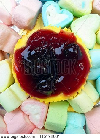 Delicious Looking Cheesecake On Colorful Marshmallows, A Delight For People With Sweettooth