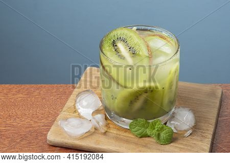 Alcoholic Drink Caipirinha Based On Kiwi And Aguardente Distilled Cocktail Drink And Fruits On Blue 