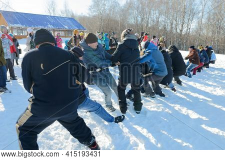 March 13, 2021: Men Tug Of War Outside In The Snow. Winter Fun. Chuvashia. Russia.