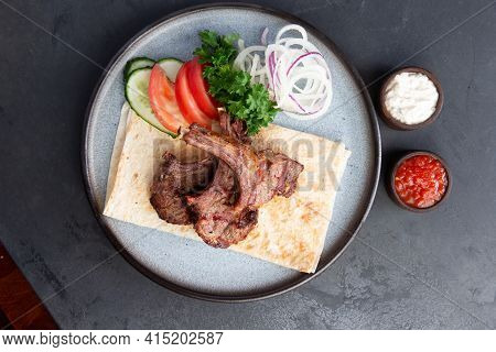 Lamb Rack In A Plate With Vegetables.