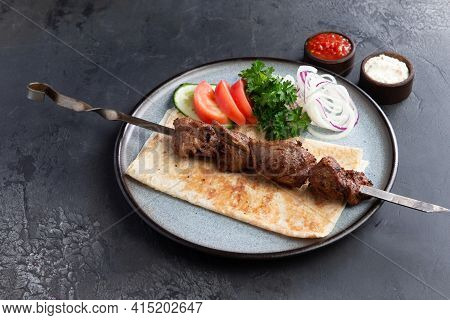 Lamb Shashlik On A Skewer In A Plate.