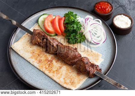 Lamb Shashlik On A Skewer In A Plate.