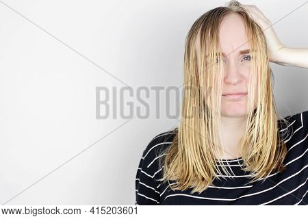 The Girl Looks In Front Of The Mirror At Her Oily Hair. Problematic Scalp And Increased Secretion Of