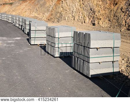 Row Of Stacked Curbstones At Road Construction Site
