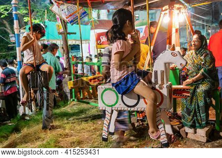 Howrah, West Bengal, India -14th April 2019: Girl Child Riding On Nagordola- A Traditional Amusement