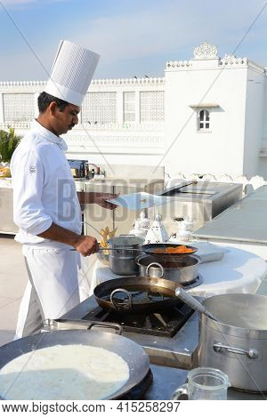UDAIPUR, INDIA - JANUARY 13, 2017: Chef preparing treats at the Taj Lake Palace Hotel. Built in 1746 as the pleasure palace of Maharana Jagat Singh II.