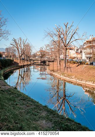 Trikala, Greece - February 6 2021: Reflections On The River Lithaios, The Landmark River That Crosse