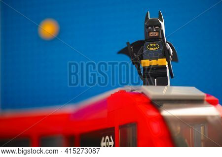 Tambov, Russian Federation - March 03, 2021 Lego Batman On The Top Of Train Against Blue Background 
