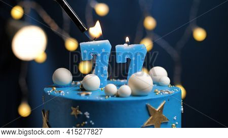 Birthday Cake Number 77 Stars Sky And Moon Concept, Blue Candle Is Fire By Lighter. Copy Space On Ri