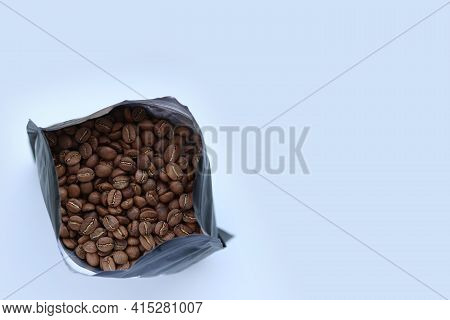 Packaged Freshly Roasted Coffee Beans.coffee In A Bag.a Bundle Of Coffee Beans On A White Background