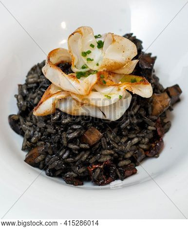 An Excellent Gourmet Dish Of Seafood Paella Style Squid Ink Black Rice In A Fancy Restaurant