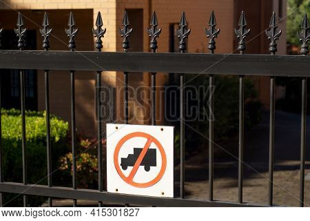 No Truck Sign On A Metal Fence Of Residential Buildings Area