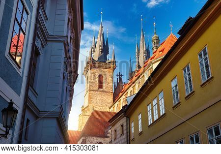 Prague, Czech Republic. Old Town square with Tyn Church (Church of Our Lady before Tyn) in Prague at sunrise. Ancient street perspective.
