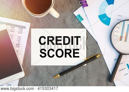 Credit Score Is Written In A Document On The Office Desk With Office Accessories, Coffee, Diagram An