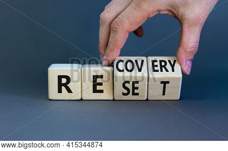 Recovery And Reset Symbol. Businessman Turns Cubes And Changes The Word 'recovery' To 'reset'. Beaut