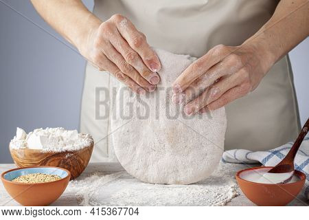 Preparation Of Homemadeturkish Flat Bread, Pide Or Pizza Base In The Kitchen. A Woman Chef Is Kneadi