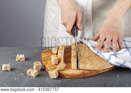 A Woman Chef Is Slicing Fresh Baked Homemade Turkish Flat Bread Known As Pide Or Pita On Wooden Chop