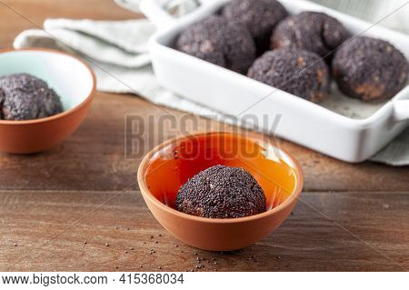 Sweet Brown Cake Balls Baked In The Oven Are Dipped In To Stump Or Syrup And Covered With Poppy Seed