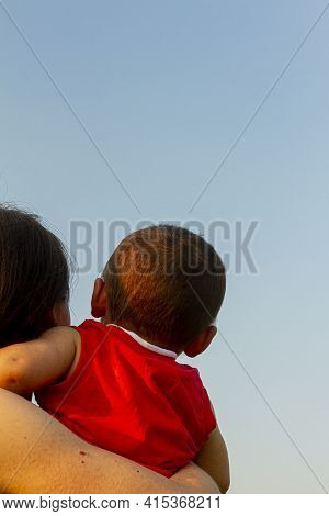 A Versatile Low Angle Close Up Isolated Image Of A Young Caucasian Mother Holding Her Little Baby Bo