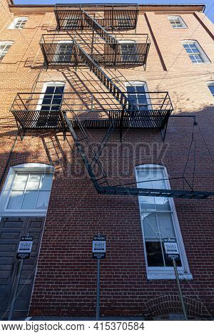 Frederick, Md, Usa 12-02-2020: Bug Eye View Of Vintage Black Metal Construction Fire Escape Ladder W