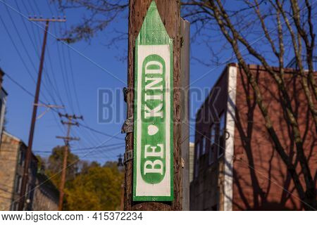 An Anonymous Wooden Sign In  Shape Of An Upward Arrow That Is Attached To A Telephone Pole In Ellico