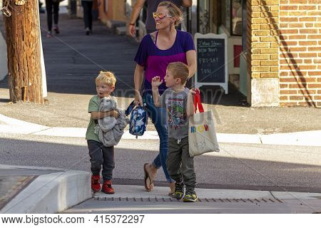 Ellicott City, Md Usa 10/07/2020: A Single Caucasian Mother With Two Little Boys Are Walking In The 