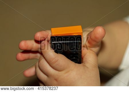 Close Up Image Of An Infant Baby's Hands As He Or She Is Trying To Interlock Two Toy Bricks. Image I