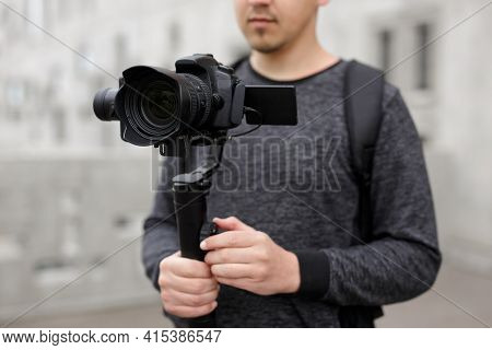 Videography, Filmmaking And Creativity Concept - Close Up Of Modern Dslr Camera On 3-axis Gimbal Sta