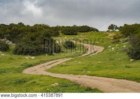 A Nature Path Going Through Fields And Hills In The Adullam Region Of Israel, On An Overcast Day.