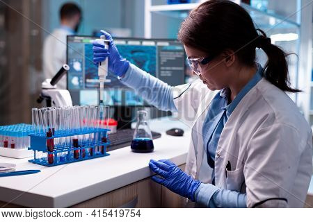 Scientist Looking Into Micropipette For Biology Test