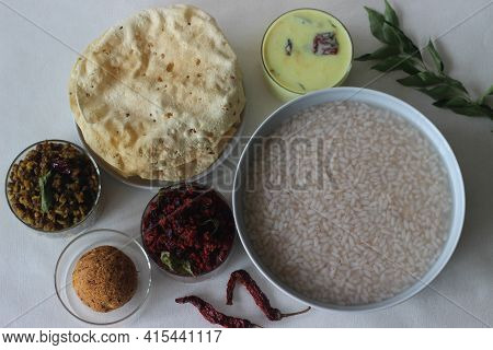 Rice Porridge Or Kanji Along With Coconut Chutney, Beetroot Potato Thoran, Stir Fried Moong, Fried P
