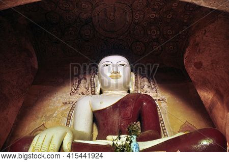 Bagan, Myanmar - November 18, 2015: Huge Colored Statue Of Buddha In Temple, From Below Shot Of Colo