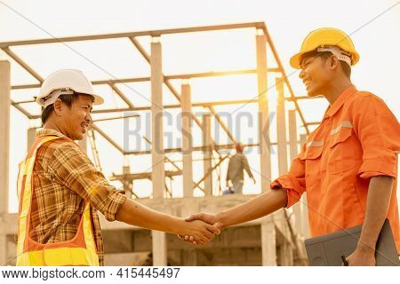 The Contractor And The Supervisor Shook Hands After Inspecting The Site,