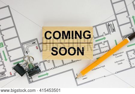 Construction Drawings And Wooden Bars With Text Coming Soon And Paper Clips. Architecture And Buildi