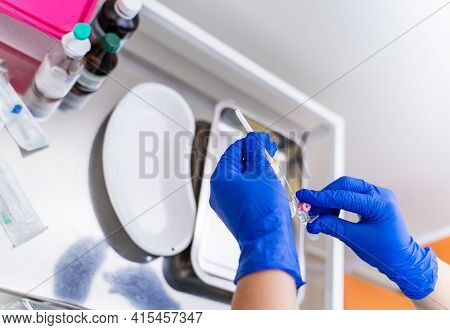 Gloved Hand Hold The Pipette With Blood For Analysis. Plastic Labware For Scientific Research. Scien