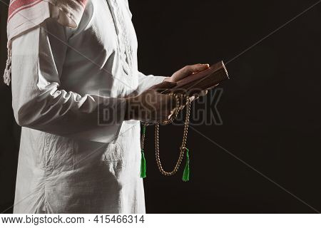 Man Traditional Arabic Clothes Holding Quran. High Quality And Resolution Beautiful Photo Concept