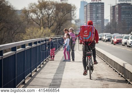 Belgrade, Serbia - March 27, 2021: Donesi Dostava Logo On A Bicycle On A Delivery Guy In Belgrade. P