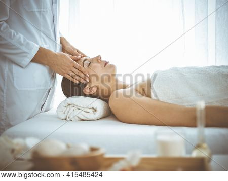 Beautiful Brunette Woman Enjoying Facial Massage With Closed Eyes Comfortable And Blissful. Relaxing
