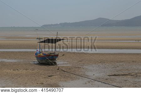 Fisherman's Fishing Boat On Sand At A Fishing Village Beach There Is An Island And Sea Background Wi
