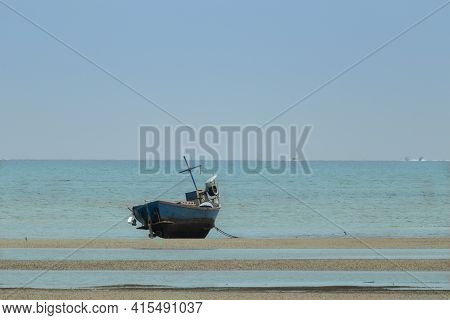 Fisherman's Fishing Boat On Sand At A Fishing Village Beach There Is An Island And Sea Background Wi
