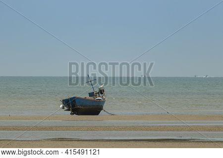 Fisherman's Fishing Boat On Sand At A Fishing Village Beach There Is An Island And Sea Background Wi