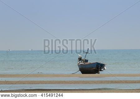 Fisherman's Fishing Boat On Sand At A Fishing Village Beach There Is An Island And Sea Background Wi