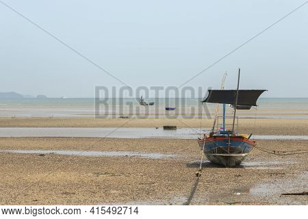 Fisherman's Fishing Boat On Sand At A Fishing Village Beach There Is An Island And Sea Background Wi