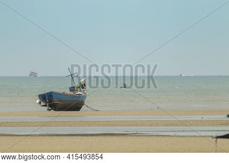 Fisherman's Fishing Boat On Sand At A Fishing Village Beach There Is An Island And Sea Background Wi